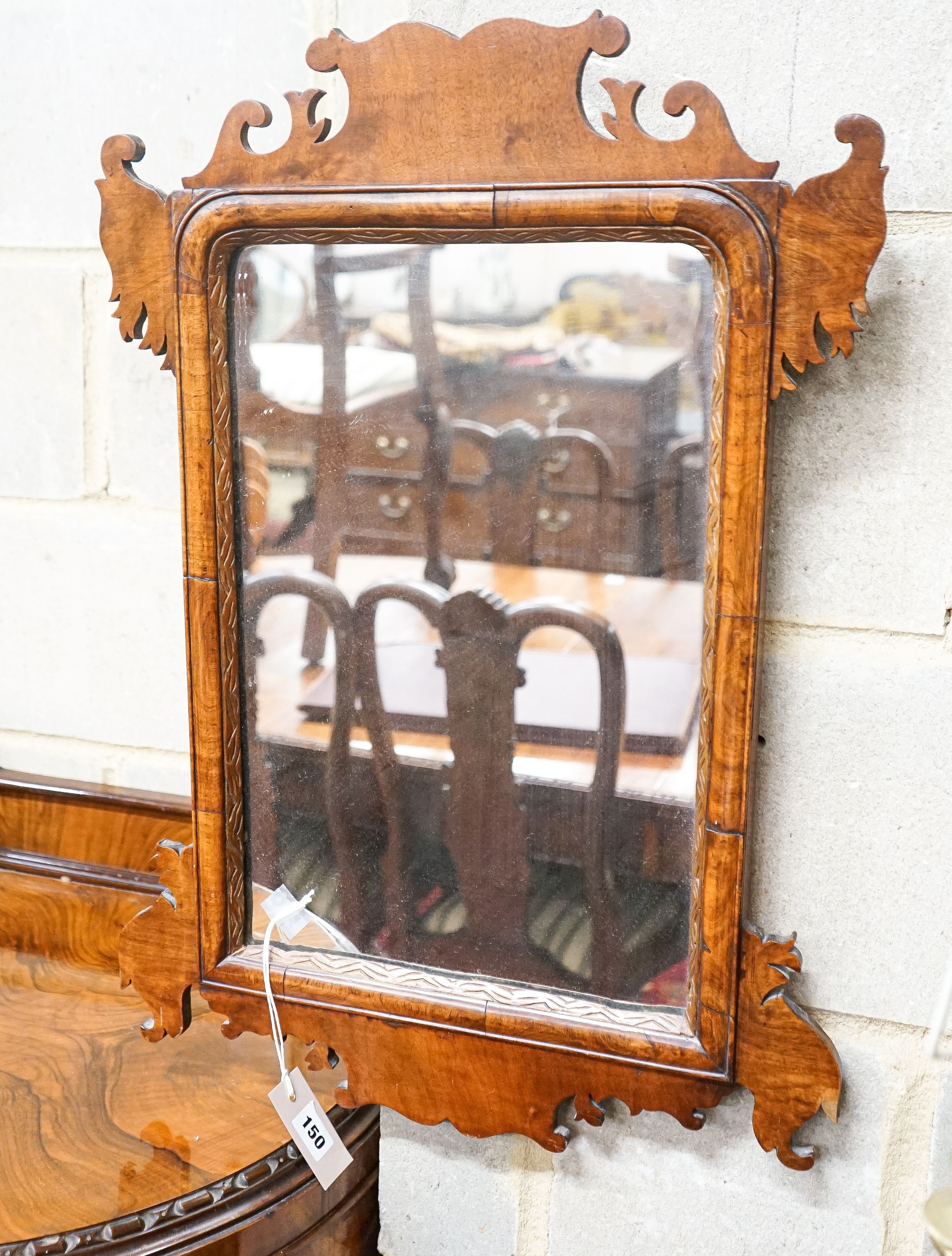 A George III style walnut fret cut wall mirror, width 47cm, height 66cm